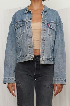 A perfect classic cropped Levi’s denim jacket in a cool blue medium wash that adds an edgy feel to any outfit. Style is slightly boxier and shorter than the original Levi’s denim jackets. Features button closure and chest and side pockets. Listed size Small. - Shoulders: 23.5” - Chest: 24” - Length: 23” - Sleeve: 22” Levi's Medium Wash Denim Jacket For Streetwear, Levi's Denim Jacket For Streetwear, Cropped Medium Wash Denim Jacket, Levi's Relaxed Fit Medium Wash Denim Jacket, Levi's Washed Denim Jacket, Medium Wash Button-up Denim Cropped Jacket, Cropped Dark Wash Denim Jacket With Button Closure, Medium Wash Cropped Jacket For Streetwear In Spring, Medium Wash Cropped Jacket For Spring Streetwear