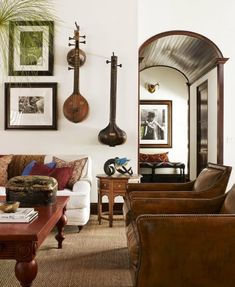 a living room filled with furniture and pictures on the wall