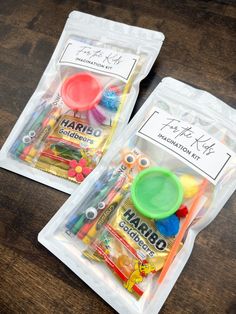 two bags filled with different colored items on top of a wooden table next to each other