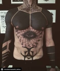 a man with tattoos on his chest has an eye in the center and is surrounded by geometric shapes