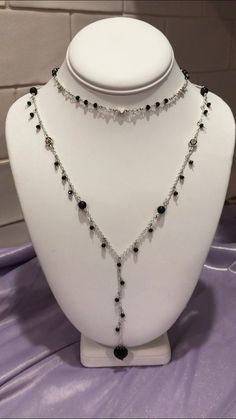 This lovely necklace set is made with silver heart charms, black beaded rosary chain, silver chain, black tourmaline beads, and a heart shaped black agate stone <3  -Adjustable -Made to order -Nickel free + hypoallergenic  -Message me for customizations / questions :) Black Metal Jewelry With Heart Beads, Black Beaded Lariat Jewelry, Black Beaded Chain Lariat Jewelry, Black Heart Beads For Jewelry Making, Sterling Silver Black Beaded Chain Necklaces, Black Sterling Silver Necklaces With Beaded Chain, Black Wire Wrapped Choker Jewelry, Black Gothic Jewelry With Beaded Chain, Black Sterling Silver Dangle Necklaces