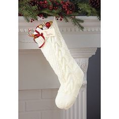 a white christmas stocking hanging from a mantel