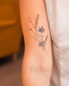 a woman with a flower tattoo on her arm