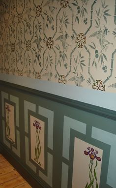 the wall paper has flowers painted on it