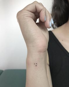 a woman with a small star tattoo on her wrist