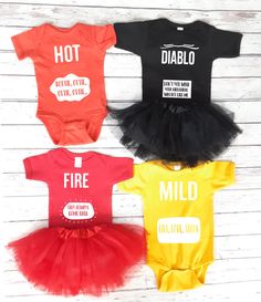 three baby onesuits in different colors with the words hot, cold, and mild