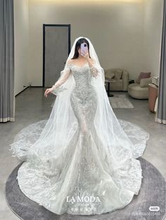 a woman in a white wedding dress standing on a round rug