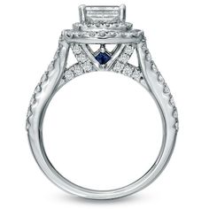 a diamond and blue sapphire engagement ring in white gold with diamonds around the band on top