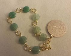 "Beautiful and delicate green aventurine glass bead bracelet. Featuring a Padre Nuestro charm. * Bracelet is approximately 7\" * Gold plated toggle clasp * 14 Kt goldfilled Padre Nuestro charm approximately 2.5 cm in diameter * length variations are possible. Please send message to store for inquiries." Aventurine Round Bracelet Gift, Aventurine Bracelet As A Gift, Round Aventurine Bracelets For Gifts, Round Aventurine Bracelets As Gifts, Aventurine Beaded Bracelet As Gift, Nickel-free Green Beaded Bracelets, Handmade Gold Aventurine Beaded Bracelets, Adjustable Green Aventurine Crystal Bracelet, Gold Aventurine Round Bead Bracelets