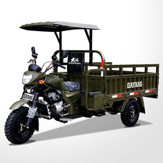 an army green motorcycle with a side car attached to the back is parked in front of a white background