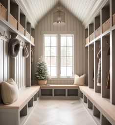 a room filled with lots of wooden shelves next to a window