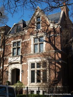 a van parked in front of a large brick house