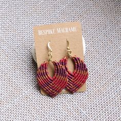 a pair of earrings sitting on top of a card