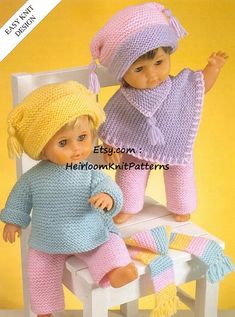 two dolls sitting next to each other on a chair