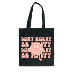 Looking for a cute tote bag to carry all your essentials this summer? This cute Don't Worry Be Happy Smiley Face bag will be perfect to add to your collection. Perfect for a day at the beach or every day life! Playful Black Bag For Everyday Use, Playful Black Bags For Everyday Use, Fun Everyday Bags With Letter Print, Fun Everyday Bag With Letter Print, Playful Black Rectangular Bag, Cute Black Canvas Bag With Large Capacity, Cute Black Canvas Travel Bag, Cute Black Canvas Bag For Daily Use, Cute Everyday Black Canvas Bag