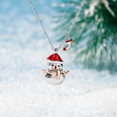 With a red hat and an orange scarf, this adorable snowman necklace is loved by all who see it. Lovely Christmas snowman design is fashionable and chic. Let you look more charming and attractive. This lovely snowman pendant would make a perfect little gift for anyone who's dreaming of a white Christmas.Carat Weight: 0.05 ctStone Size: 1 mmStone Type: Jeulia® StoneNumber of Stones: 2 Stone Color: Fancy BlackStone Shape: RoundWeight: 4.62 gWidth: 11.7 mmHeight: 18 mmThickness: 5 mmMaterial: 925 Sil Winter Gift Red Jewelry, Winter Season Red Jewelry Gift, Red Jewelry For Winter Gifts, Snowman Jewelry, Snowman Necklace, Sliver Necklace, Dreaming Of A White Christmas, Snowman Design, A White Christmas