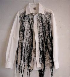 a white shirt with black lace on it