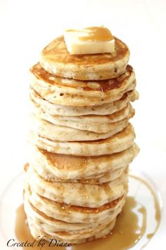 a stack of pancakes topped with butter and syrup