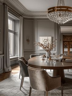 a dining room table with chairs and a chandelier