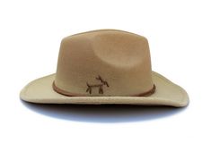 "The Victorio hat part of the Tucson Collection Type: Center Dent Western Wide Brim Fedora Adjustable Size: With a tie of a knot, adjust the fit of your hat to the ideal size from 21 ¼ to 23 ¼ inches. Dimensions: Wired Brim: 2 7/8\", Crown: 4\" Color: Distressed Camel, Sun bleached for 32 hrs. Materials: 65% Cotton , 35% Polyester Natural Leather Cord Leather Strap Ring neck Feather Handstitched Arrow & Horse motif Origin: All of our hats begin in Ecuador as the body is molded, then complete Horse Motif, Womens Fedora, Wide Brim Fedora, Tucson Az, Felt Hat, Hat Band, Fedora Hat, Custom Hats, Wide Brimmed