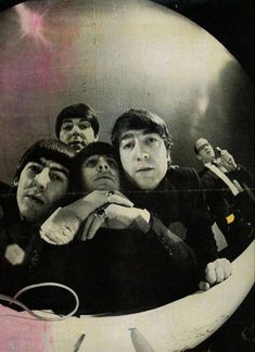 the beatles posing for a photo in front of a mirror