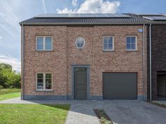 a two story brick house with an attached garage