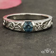 a ring with a blue stone in it