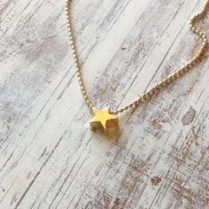 A petite tiny beautiful shiny gold star necklace pendant .Very tiny necklace elegant and cute, a perfect gold necklace for every day wear. Simple, dainty and classic! Necklace Measures Approximately 17"Made from 14k gold filled chain and lobster claps You can adjust the size on request.All my jewelry are packed in an elegant gift box.If you want to give it as a gift you can specify the address and I'll be happy to send it on your behalf.To see more, please visit my shop at :  http://www.etsy.com Dainty Yellow Gold Star Charm Necklace, Dainty Star Of David Charm Necklace With Delicate Chain, Gold Minimalist Star Of David Charm Necklace, Tiny Star Shaped Minimalist Necklaces, Tiny Star Minimalist Necklaces, Minimalist Tiny Star Necklaces, Gold Star Charm Necklace With Delicate Chain, Minimalist Star Charm Necklace With Delicate Chain, Dainty Star Charm Necklaces