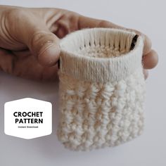 a hand holding a crochet pot holder with the bottom half open to show it's inside