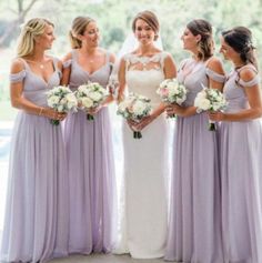 the bride and her bridesmaids are all wearing lavender colored dresses