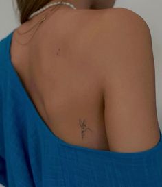 a woman with a small tattoo on her back