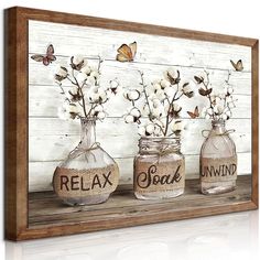 three glass jars with flowers and butterflies in them sitting on a shelf next to a wall