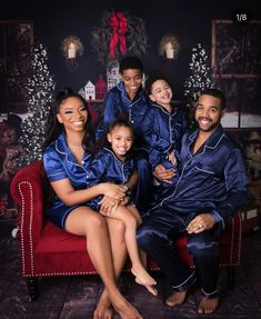 a family in matching blue pajamas posing for a photo