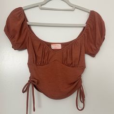 Women’s Brown Tie Tee-Shirt Ruched Cup Going Out Top Ruby And Jenna Top Perfect Condition And Never Worn Size Small Ruched Tops For Day Out In Fall, Ruched Tops For Fall Day Out, Casual Ruched Tops For Day Out, Cotton Ruched Tops, Stretch Tops With Drawstring For Day Out, Stretch Drawstring Tops For Day Out, Brown Short Sleeve Crop Top For Fall, Casual Ruched Tops For Fall, Casual Drawstring Tops For Day Out