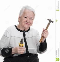 an elderly woman holding two hammers in her hands