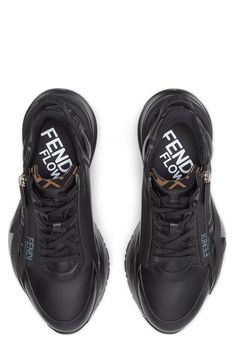 An F-molded rubber sole, logo lettering at the heel and an FF-printed sidewall add to the high-fashion flow of this mixed-media sneaker with a diagonal zip. Elastic laces; side zip closure Removable insole Leather and textile upper and lining/rubber sole Made in Italy Men's Designer Shoes Luxury Black Custom Sneakers With Stitched Sole, Luxury Black Modern Sneakers, Fendi Flow Sneakers, Flow Logo, Mens Designer Shoes, Elastic Laces, Low Top, Side Zip, Top Sneakers