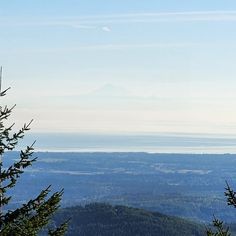 a view from the top of a mountain with trees