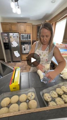 a woman is making cookies in the kitchen