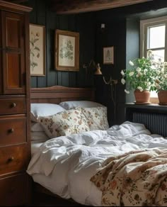 a bedroom with black walls and white linens