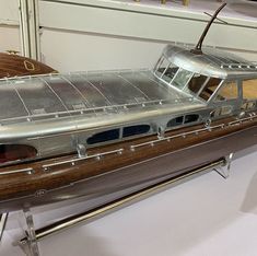 a model boat sitting on top of a metal stand