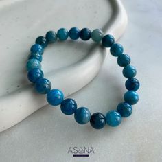 This beautiful apatite bracelet is perfect for adding a touch of natural elegance to any outfit. The soft blue stones are said to promote peacefulness and clarity of thought, making it the perfect accessory for those who need a little calm in their lives.

This apatite bracelet is the perfect way to get your daily crystal healing fix! The beautiful blue stones are said to promote creativity and intuition while helping to clear blockages and negativity. Wear it as a reminder to stay positive and open-minded, and enjoy the many benefits of crystal healing! Apatite Bracelet, Blue Stones, Open Minded, Blue Apatite, Stay Positive, Crystal Shop, Blue Stone, Beautiful Blue, Crystal Healing