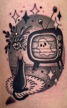 a black and white tattoo with a tv on it's side, surrounded by stars