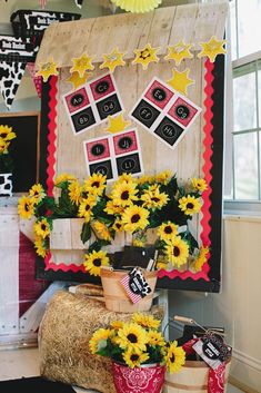 a bulletin board with sunflowers on it and other decorations in the back ground