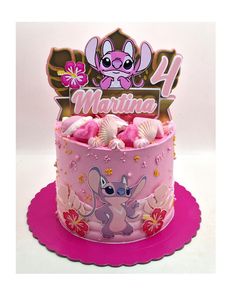 a birthday cake with pink frosting and an image of a cartoon character on top