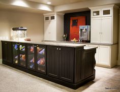 a kitchen with an island and refrigerator in it