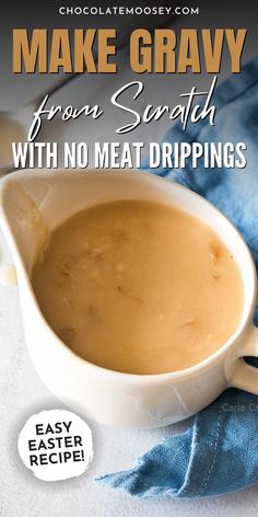 a white bowl filled with gravy on top of a blue towel