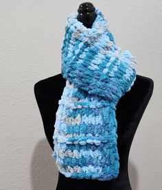 This listing is for a beautiful hand knitted scarf made with loop yarn. The color is Cloudy Sky. It is perfect for any occasion and goes well with any outfit. It is very soft, warm, cozy, and comfortable. It measures approximately 6 inches in with and 62 inches in length.  Made in a smoke free, pet free home. Machine wash and dry on a delicate cycle.  Please take a moment to check out the other listings available in my shop.  This listing is ready to ship and you will get it quick!! Crochet Yarn Scarves For Cold Weather, Cozy Hand Knitted Yarn Infinity Scarf, Knit Acrylic Yarn Scarves, One Size Scarf Knitting Pattern, Blue Knitted Yarn Scarves, One Size Yarn Scarves For Cold Weather, Yarn Scarves For Cold Weather, Blue Knitted Yarn Scarf, Hand Knitted Acrylic Yarn Scarf For Cold Weather