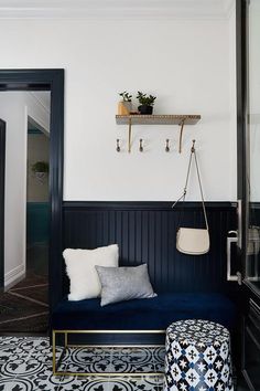 a black and white room with a blue couch