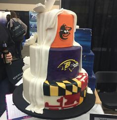 a multi - tiered cake with baltimore browns on it