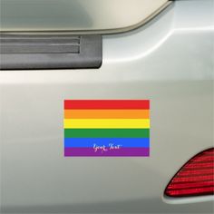 a rainbow sticker on the back of a car